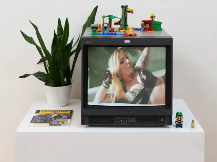 "The Sex Worker's Guide to Parenting" documentary playing on a small old school television.